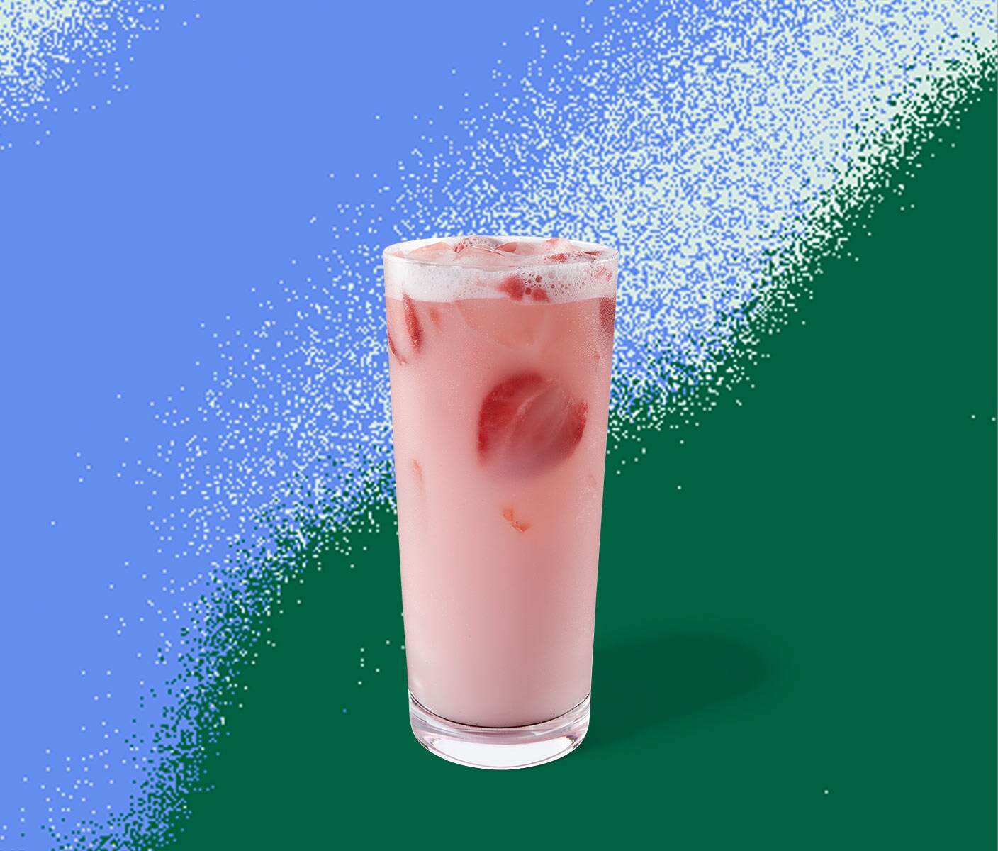 A light-pink iced drink with strawberry inclusions in a tall glass.