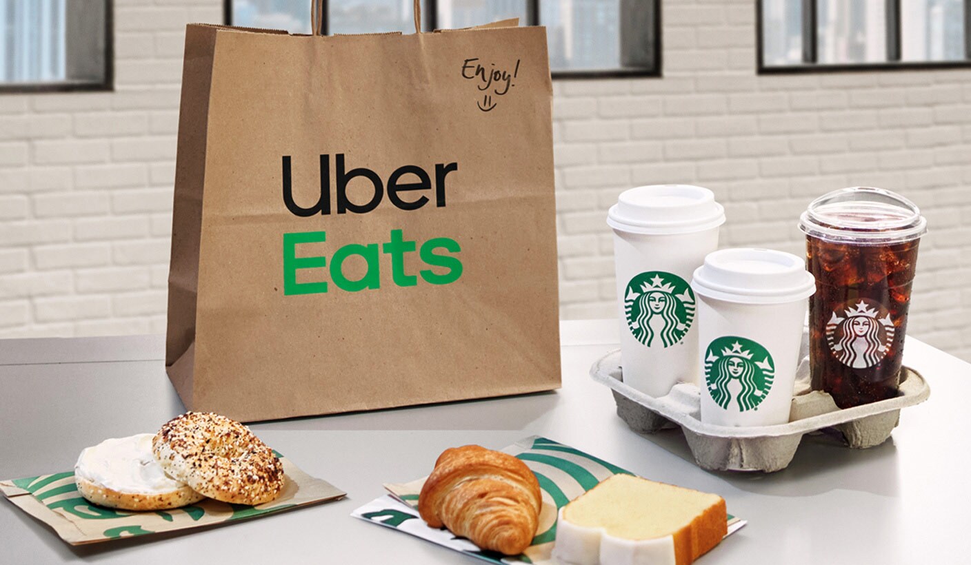 Featuring an Uber Eats bag and Starbucks products on a table.